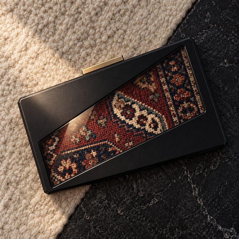 Folded Field clutch seen from above on wool and dark stone